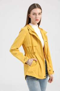 Detail of a bright yellow hooded raincoat with adjustable waist drawstring and snap cuffs