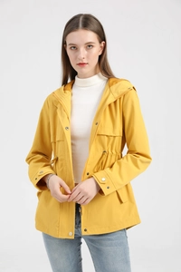 Detail of yellow hooded windbreaker with adjustable waist drawstring and metal snap buttons