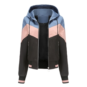 Detail of hooded windbreaker with blue, pink, and black color-block design and ribbed cuffs