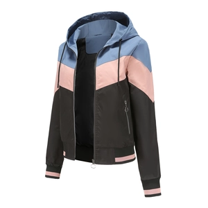 Detail of color-block hooded jacket showing tricolor design and ring pull zippers