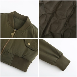 Detail view of olive green bomber jacket featuring quilted lining and ribbed cuffs and hem