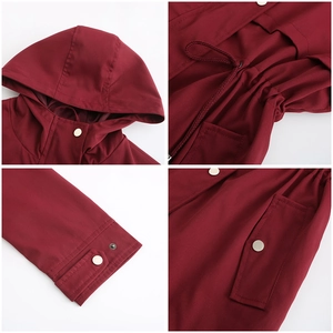 Detail of wine red hooded raincoat with adjustable drawstring and metal button pocket
