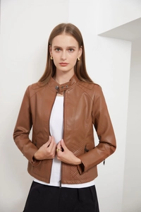 Detail of brown faux leather jacket featuring stand collar and quilted diamond pattern