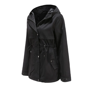 Detail of black hooded windbreaker featuring adjustable waist drawstring and pocket