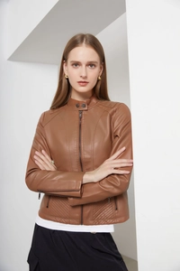 Close-up of brown faux leather jacket featuring quilted shoulder detail and metal zippers