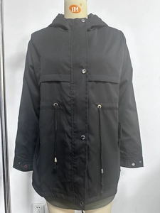 Detailed view of black hooded jacket with adjustable drawstring waist and metal buttons