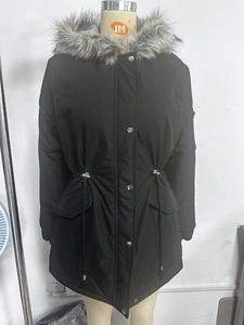 Detail of black parka jacket featuring faux fur hood trim and silver metal snap buttons