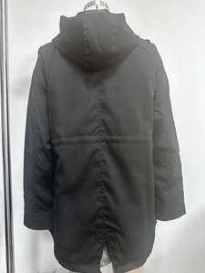 Detail of fishtail hem and drawstring waist on black hooded outdoor windbreaker coat