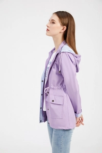 Close-up of lavender waterproof windbreaker featuring drawstring waist and striped hood lining