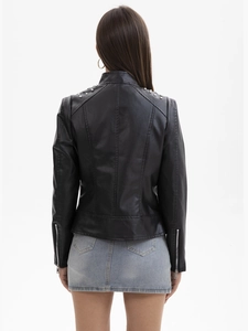 Detail of silver studded shoulders and sleek leather texture on a black biker jacket