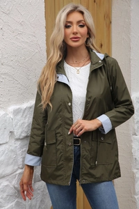 Detail of army green trench coat featuring drawstring waist and blue striped lining