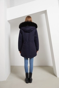 Rear view of a navy blue winter parka with an adjustable drawstring waist and black fur collar
