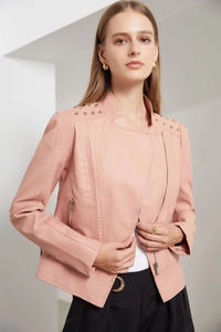 Detailed view of pink biker jacket with silver metal studs and asymmetric zipper