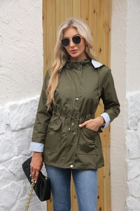 Detail of army green hooded trench coat featuring drawstring waist and striped lining