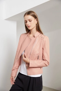 Close-up of pink faux leather jacket featuring silver stud details and metal zippers