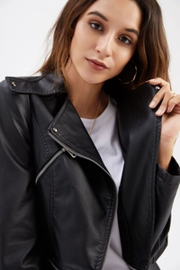 Detail of a black biker jacket with asymmetric zipper and metal lapel snaps on faux leather