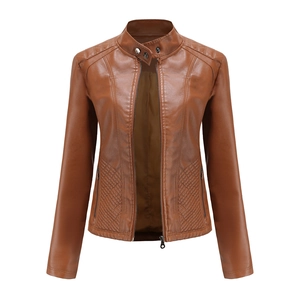 Detail of caramel faux leather jacket with diamond quilted panels and silver snap button
