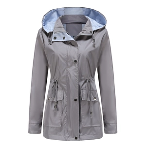 Detail of grey hooded windbreaker featuring blue striped lining and adjustable drawstring