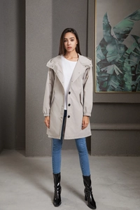 Detail of light gray water-resistant long windbreaker with drawstring hood and elastic cuffs