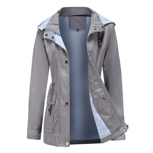 Detail view of grey hooded raincoat with striped lining and adjustable drawstring waist