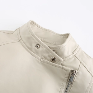 Close-up of beige leather jacket with stand collar, silver snaps and metal zipper details