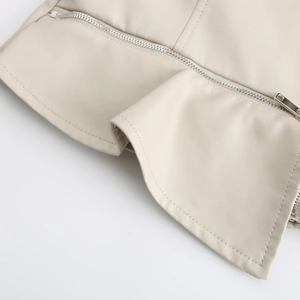 Detailed close-up of cream PU leather jacket showing metal zipper and fine double stitching