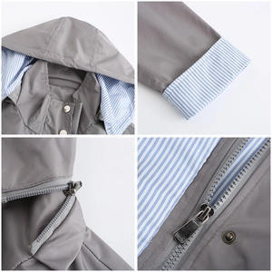 Detail view of gray raincoat with striped lining, metal zipper and snap buttons closure