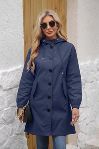 Detail of dark blue waterproof windbreaker featuring adjustable hood and snap buttons