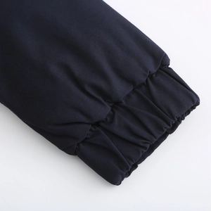 Close-up detail of dark blue parka jacket with elastic windproof ribbed cuffs