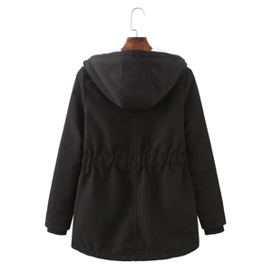 Detail view of black parka showing drawstring waist design and ribbed windproof cuffs