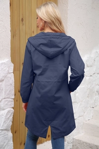Detail view of water-resistant hooded trench coat back with drawstring waist and slit hem