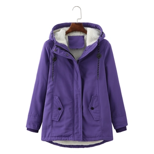 Close-up of women's purple parka featuring soft white sherpa lining and windproof fabric