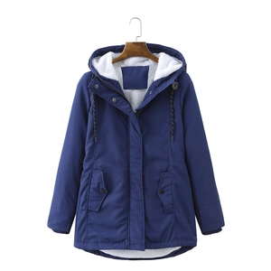 Detail of navy parka lining showing white lamb wool material and drawstring hood
