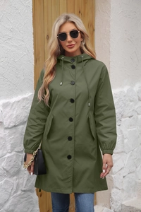 Detail of water-resistant olive green hooded windbreaker with black buttons and pockets