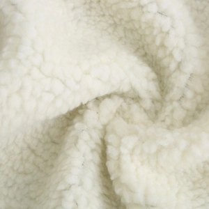 Detailed macro view of soft white faux shearling texture on winter parka coat