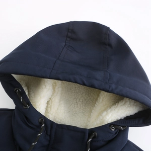 Close-up of winter parka hood with warm white sherpa fleece lining and textured navy fabric