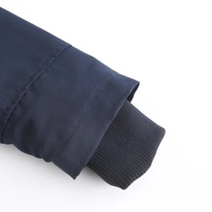 Detail of navy windproof parka sleeve with thermal black ribbed knit inner cuff