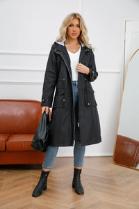 Detail of waterproof hooded windbreaker featuring functional drawstring waist and large flap pockets