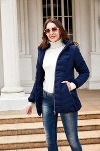 Classic navy blue hooded puffer jacket for women styled with a chic white turtleneck