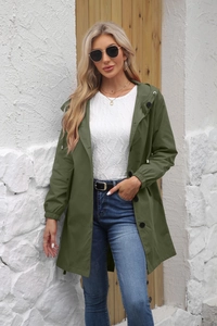 Detail of army green waterproof trench coat with drawstring hood and elastic cuffs