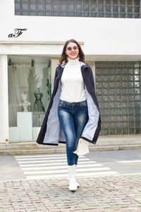 Detail of long blue hooded trench coat with stylish blue and white striped lining