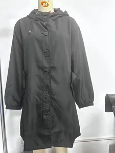 Close-up of waterproof black hooded trench coat with adjustable drawstring and flap pockets