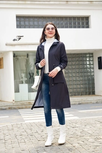 Detail of navy blue hooded trench coat with striped lining and adjustable drawstring waist