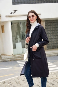 Stylish women's long navy blue hooded windbreaker featuring a chic striped lining