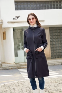 Detail of navy blue hooded trench coat featuring waist drawstring and large flap pockets