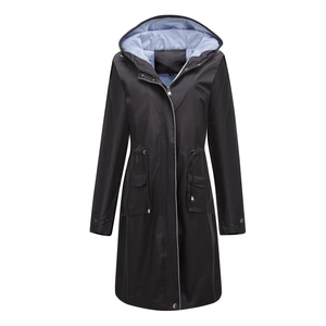 Detail of waterproof black parka featuring blue striped lining and adjustable waist drawstring