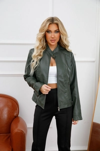 Detailed close-up of dark green motorcycle leather jacket with metal zipper pockets