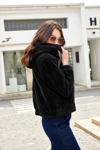Detail of soft black plush faux fur hooded jacket texture and casual winter styling