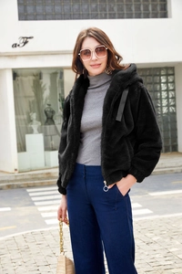 Detail of soft faux fur texture on a black hooded jacket with metallic zipper pulls