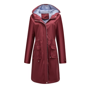 Close-up of maroon waterproof raincoat featuring striped lining and drawstring waist detail
